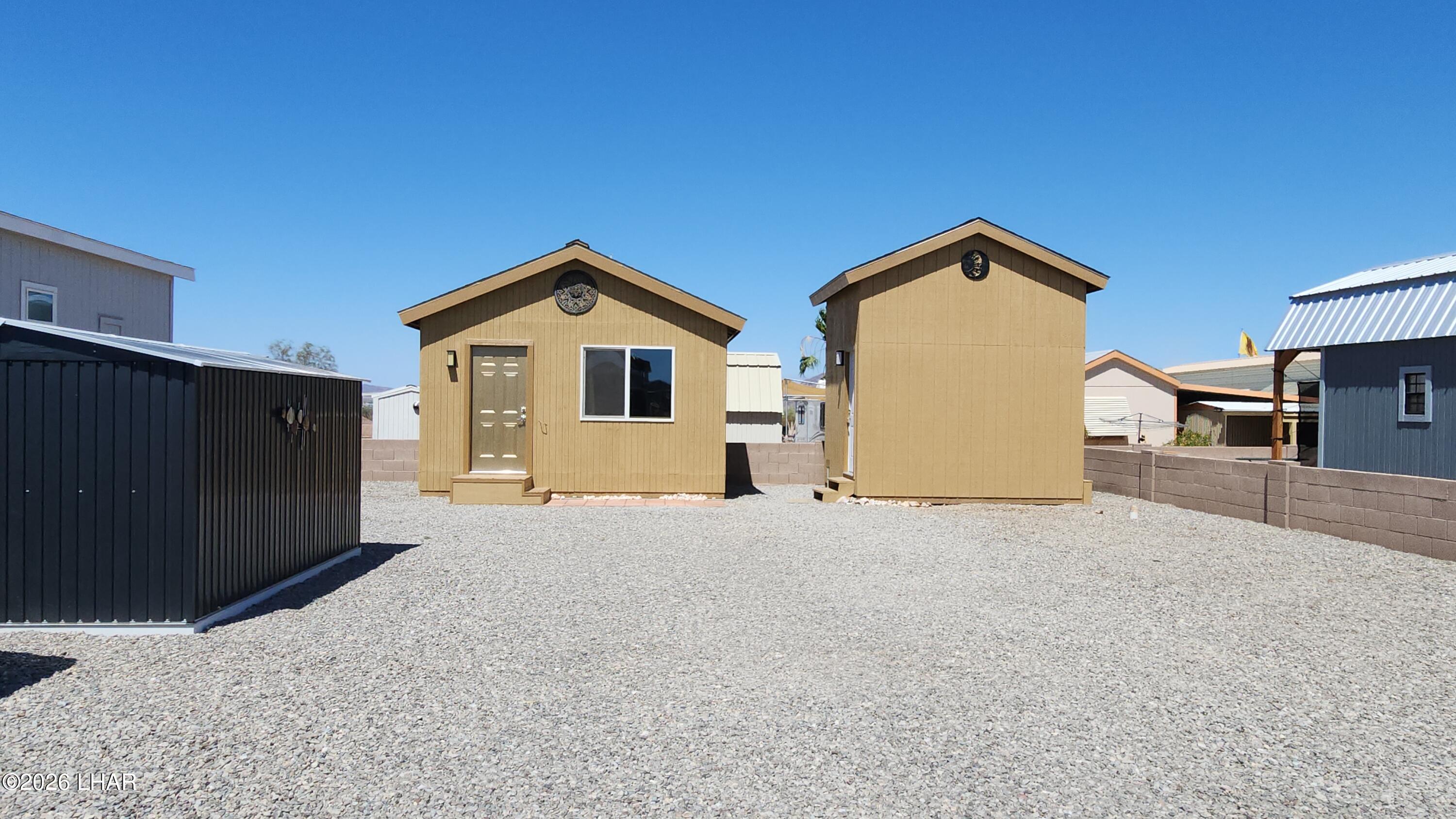 30 North Juniper Road Quartzsite, AZ 85346 - Photo 13 of 26 a front view of a house with a yard and garage