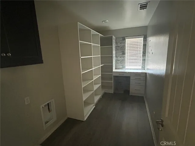 en empty room with windows and fan