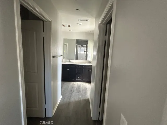 a bathroom with a double vanity sink mirror and shower
