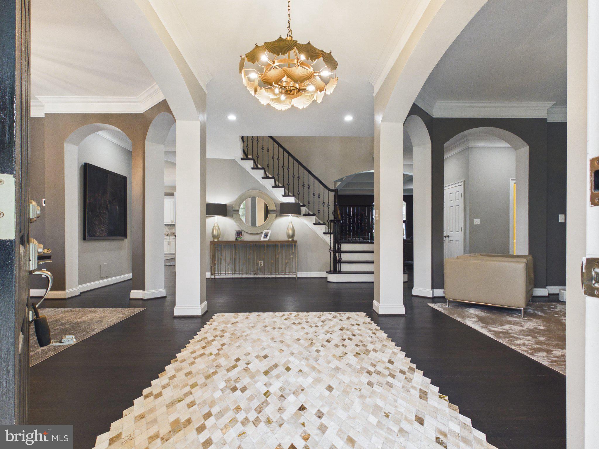 38565 Piggott Bottom Road Hamilton, VA 20158 - Photo 5 of 85 a bedroom with a large bed and a chandelier