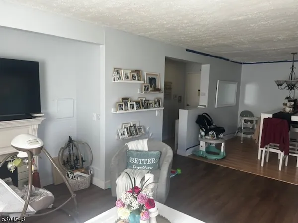 a room with furniture a rug and white walls