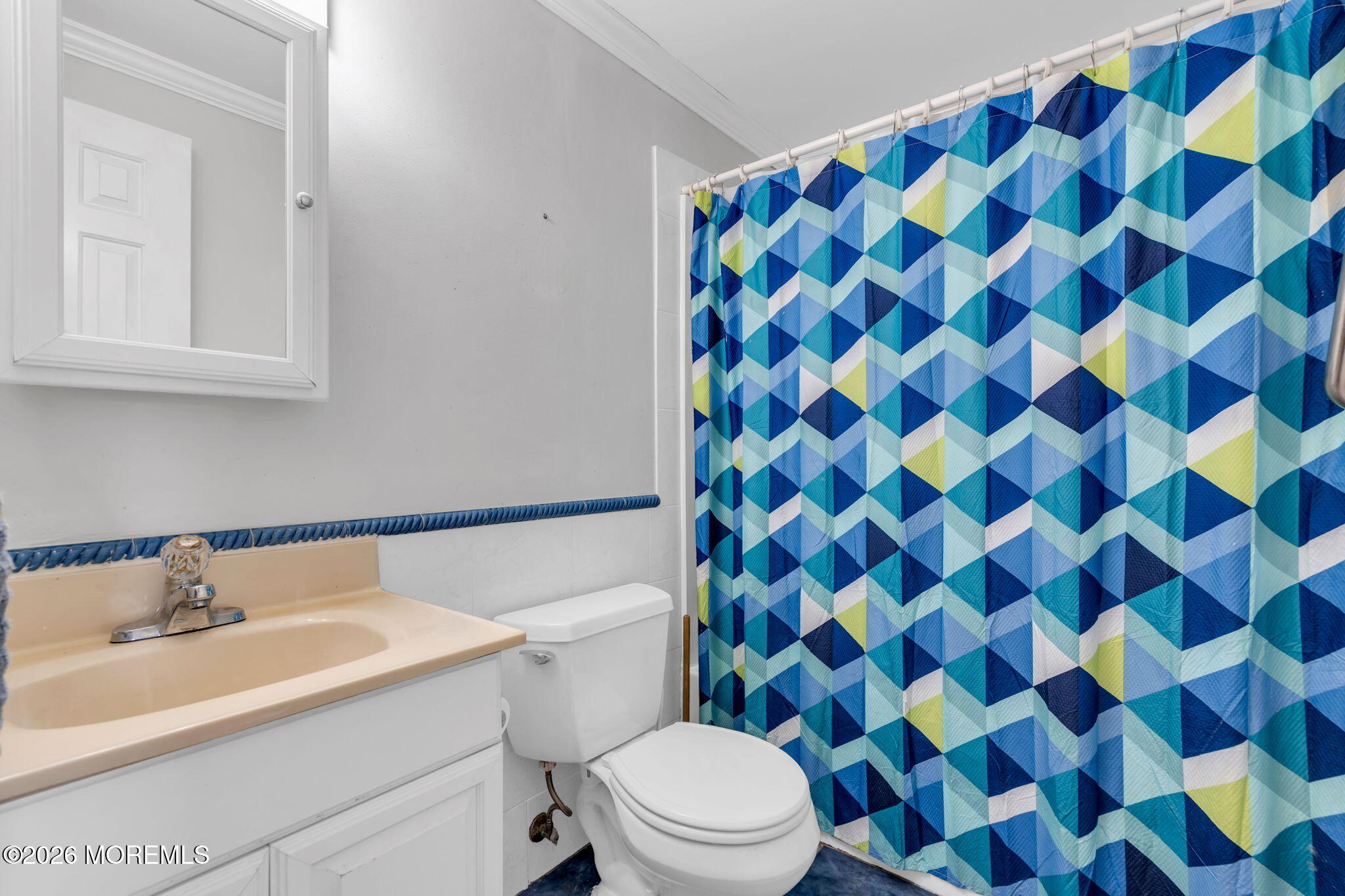 a bathroom with a sink and mirror with toilet