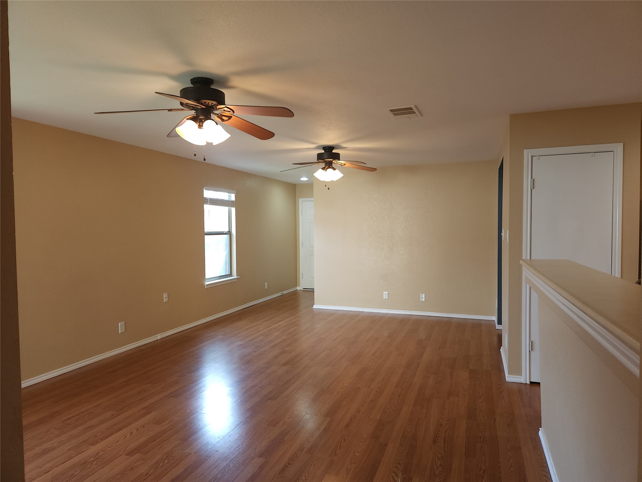 273 Tower Drive Kyle, TX 78640 - Photo 3 of 13 a view of an empty room with a window and wooden floor