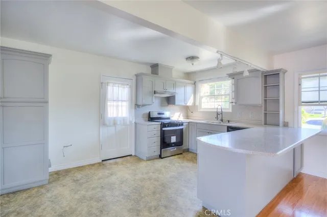 a kitchen with a sink stove and cabinets