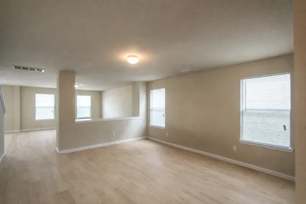 an empty room with windows and entrance
