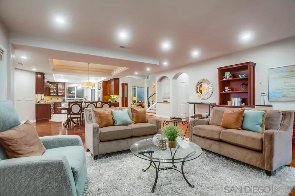 2234 Ivy Road Oceanside, CA 92054 - Photo 12 of 29 a living room with furniture kitchen view and a wooden floor