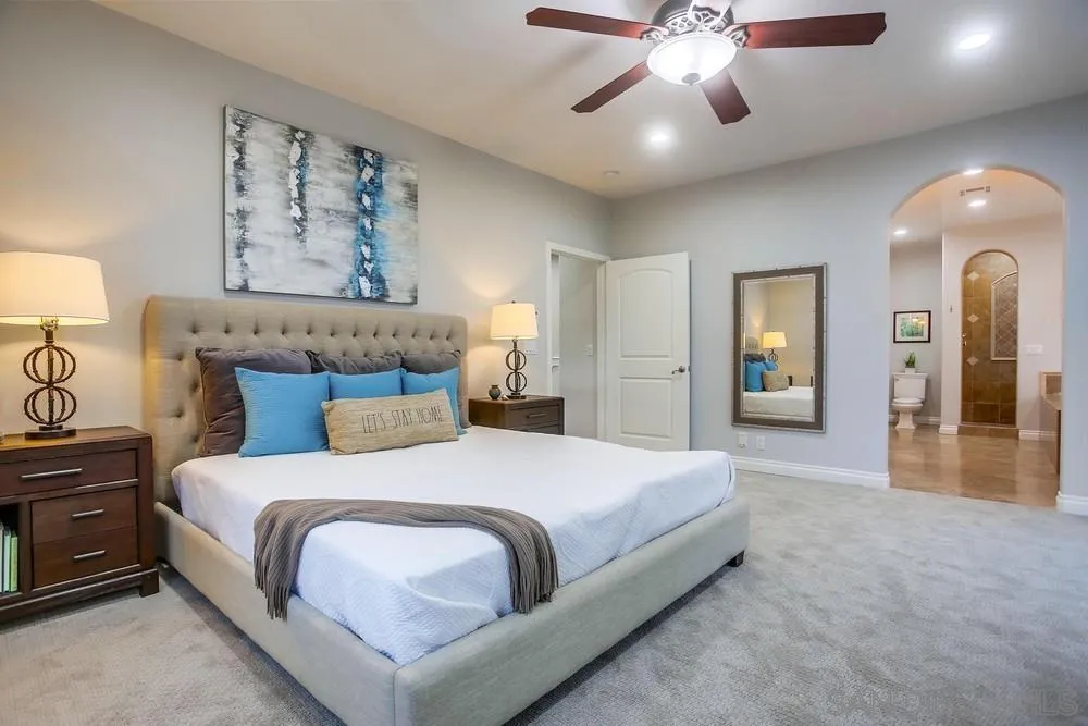 2234 Ivy Road Oceanside, CA 92054 - Photo 19 of 29 a bedroom with a large bed and a chandelier