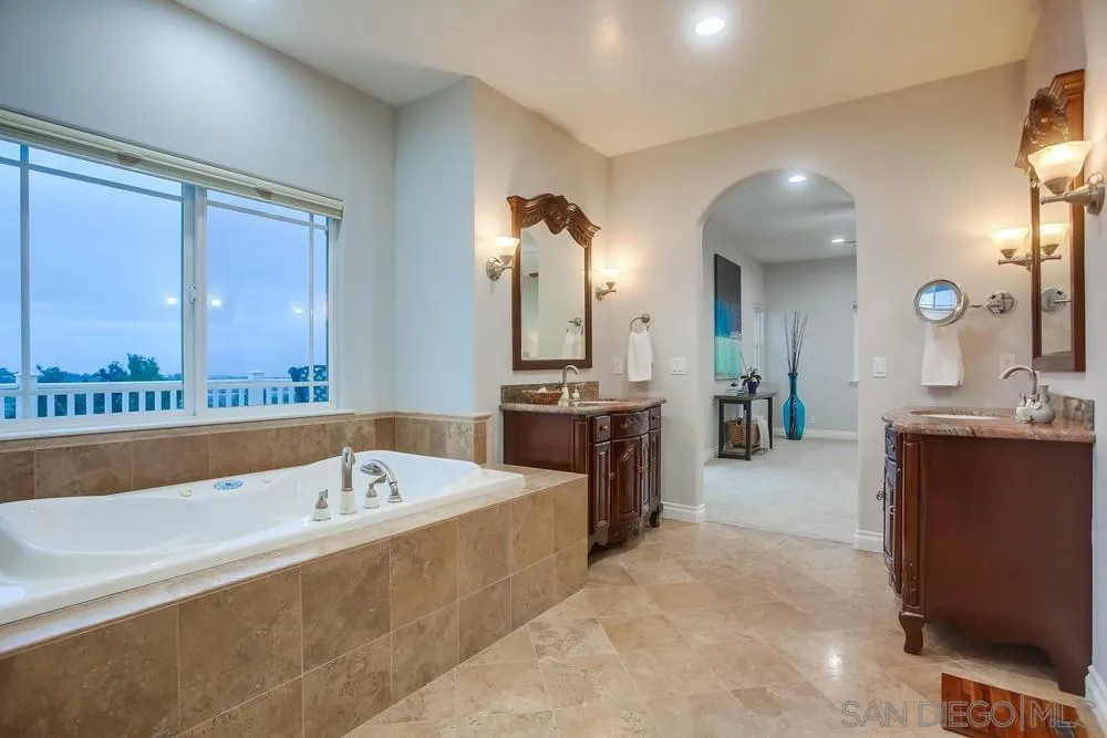 2234 Ivy Road Oceanside, CA 92054 - Photo 21 of 29 a spacious bathroom with a tub a double vanity sink a mirror and a shower
