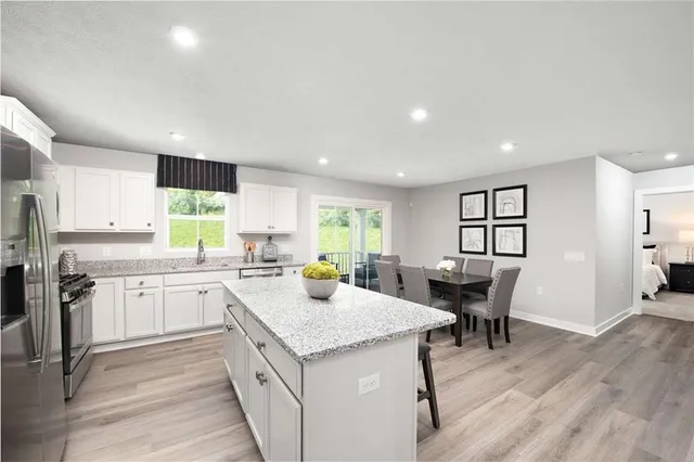 a kitchen with a sink stove and cabinets