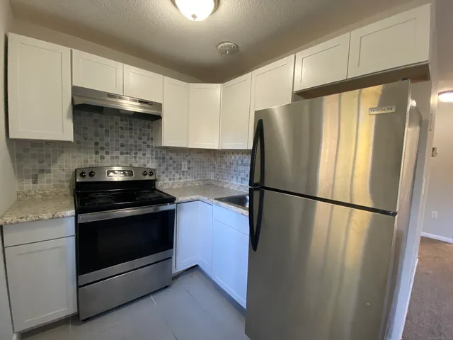 a white refrigerator freezer sitting in a kitchen