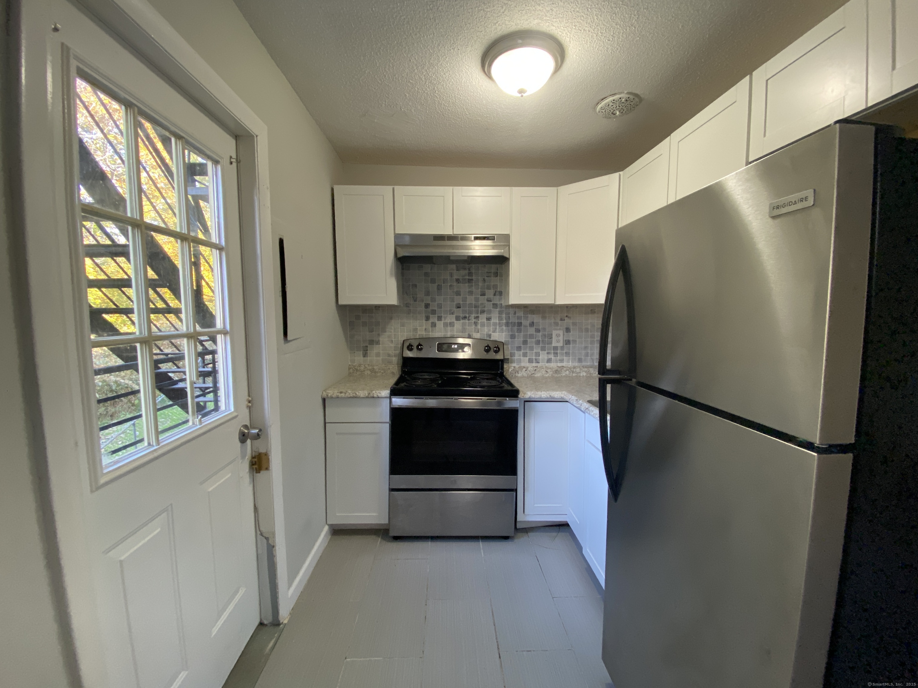 32 Old Foxon Road, Unit 27 East Haven, CT 06513 - Photo 2 of 6 a kitchen with a refrigerator and a stove
