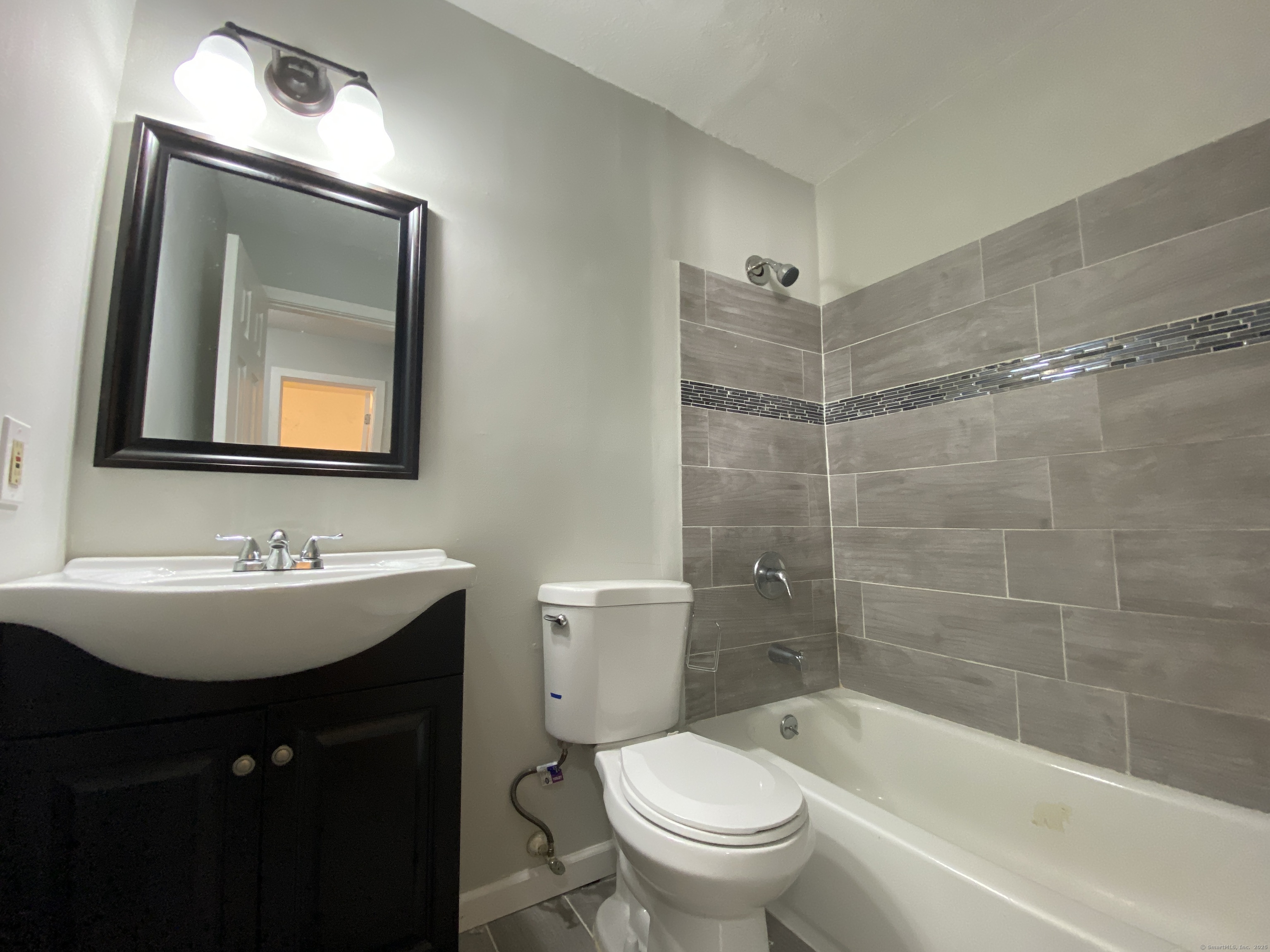 32 Old Foxon Road, Unit 27 East Haven, CT 06513 - Photo 5 of 6 a bathroom with a bathtub shower sink mirror and toilet