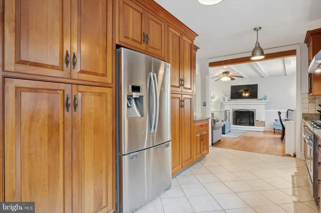 a kitchen with stainless steel appliances a refrigerator and a stove top oven