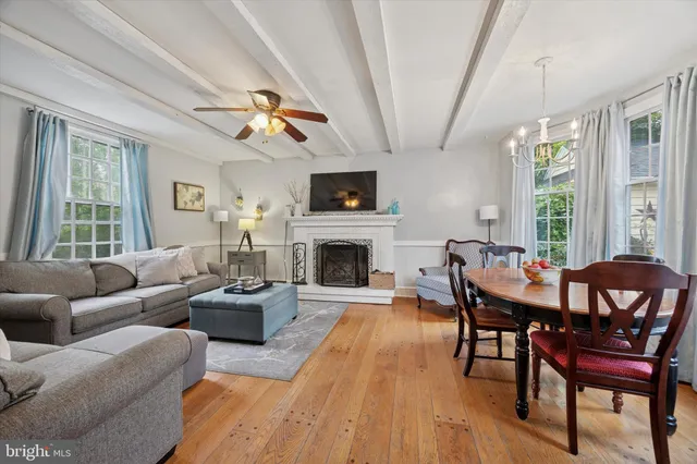 a living room with furniture a fireplace and a large window