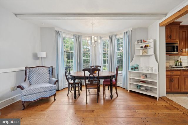 a living room with furniture and floor to ceiling windows
