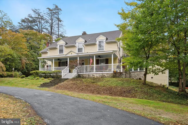 a front view of a house with a yard table and chairs