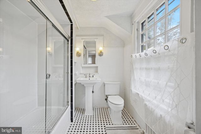 a bathroom with a toilet a sink and shower