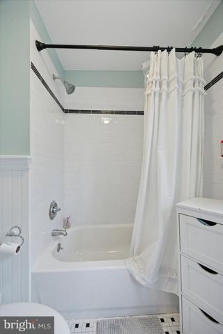 a bathroom with a shower curtain and a bathtub