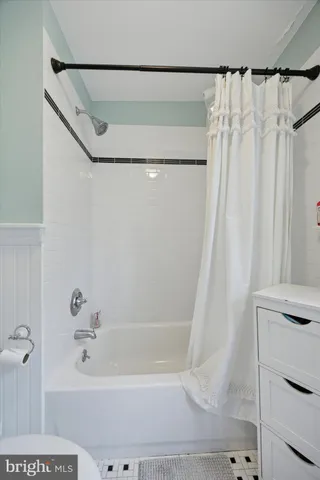 a bathroom with a shower curtain and a bathtub