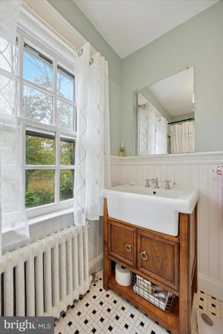 a bathroom with a sink mirror and a bathtub