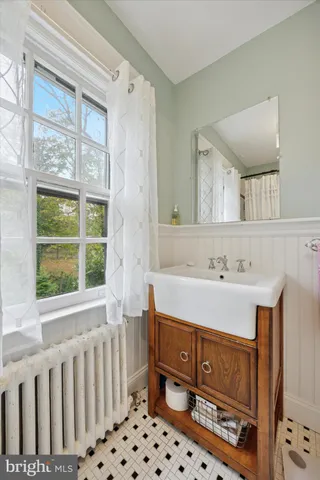a bathroom with a sink mirror and a bathtub