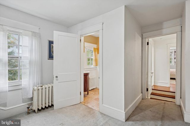 a view of a hallway with closet and a livingroom