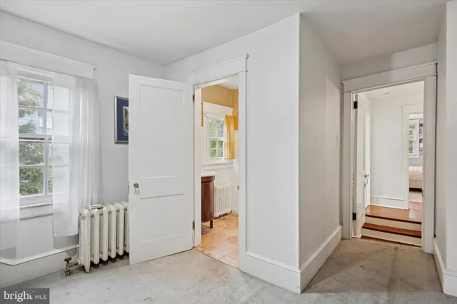 a view of a hallway with closet and a livingroom