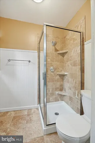 a bathroom with a shower and a toilet
