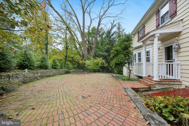 a pathway of a house with a yard