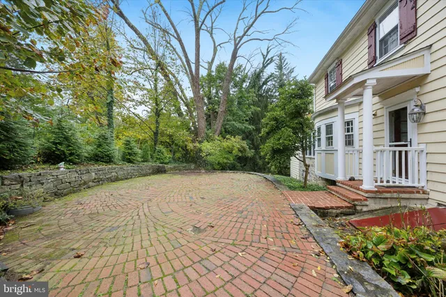 a pathway of a house with a yard