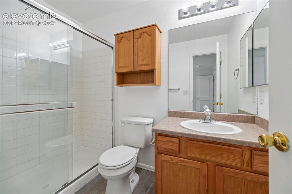 431 Kitfield View Colorado Springs, CO 80916 - Photo 21 of 27 a bathroom with a sink toilet and shower