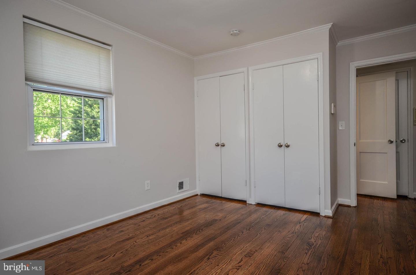 2315 Plyers Mill Road Silver Spring, MD 20902 - Photo 15 of 28 a view of an empty room with wooden floor and a window