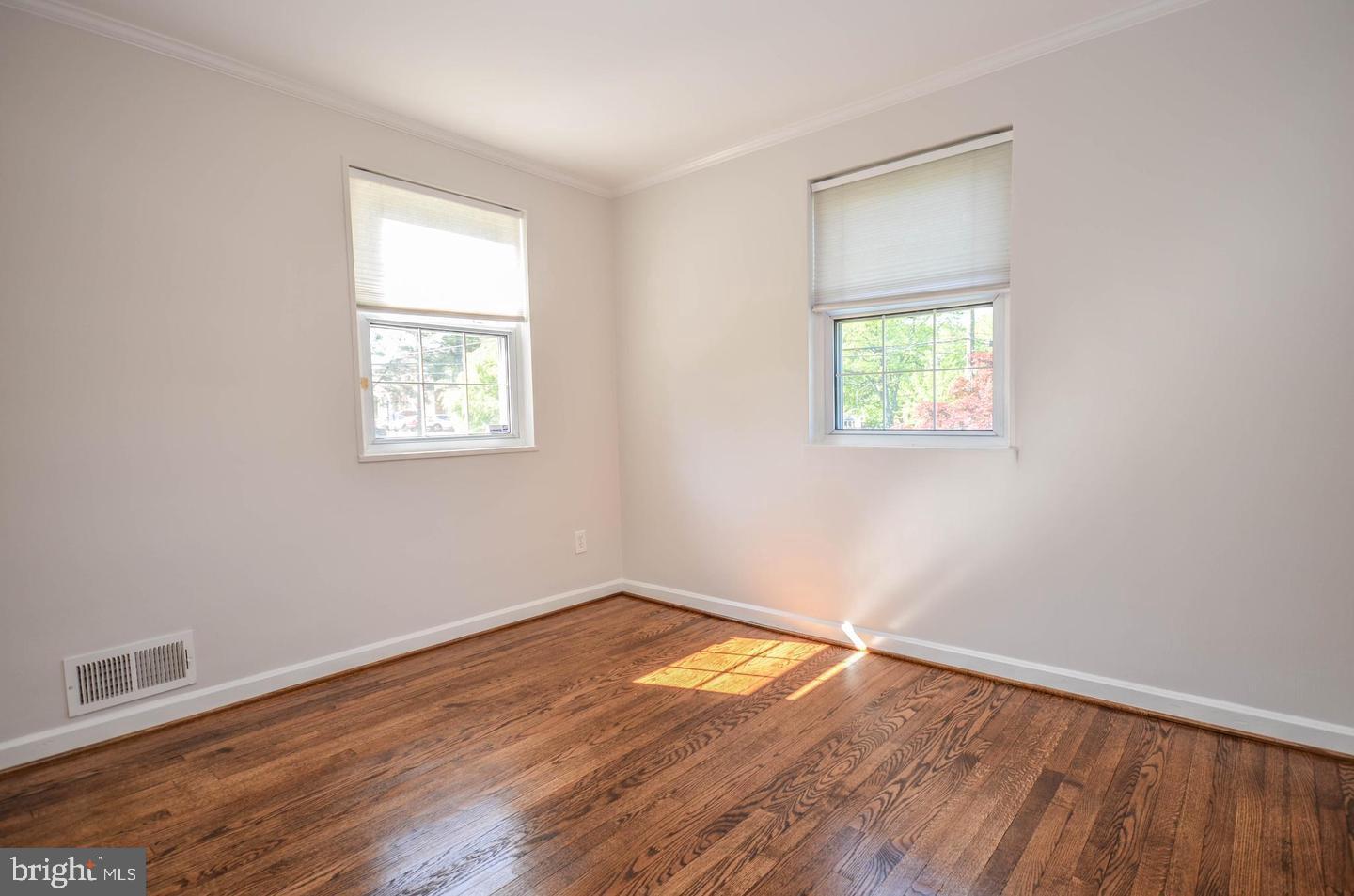 2315 Plyers Mill Road Silver Spring, MD 20902 - Photo 16 of 28 an empty room with wooden floor and windows