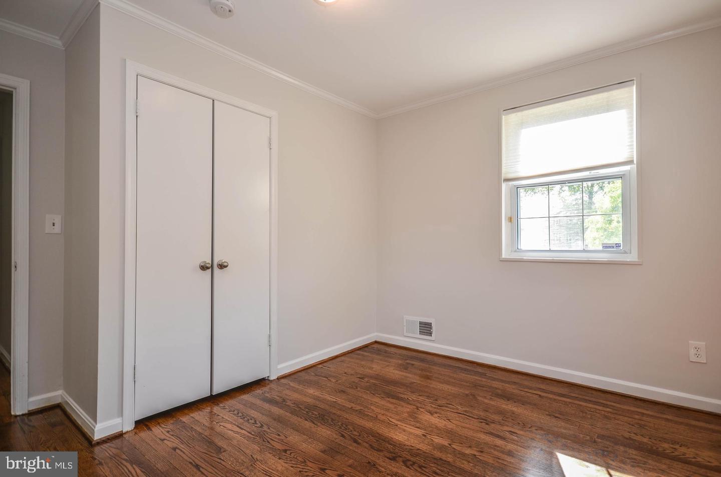 2315 Plyers Mill Road Silver Spring, MD 20902 - Photo 21 of 28 an empty room with wooden floor closet and windows
