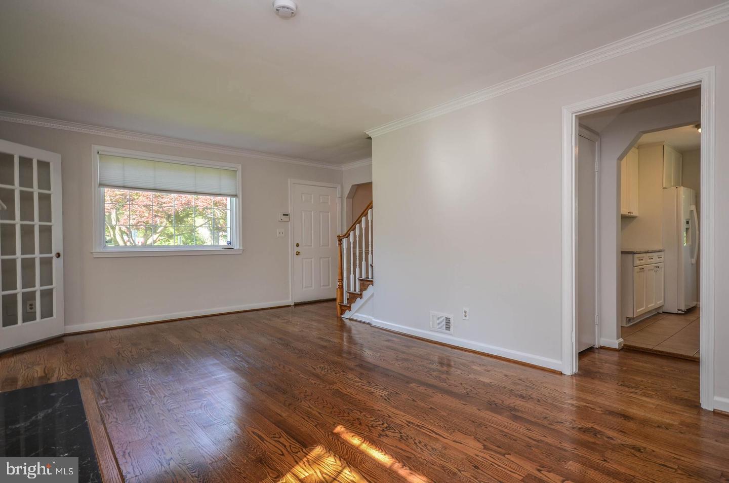 2315 Plyers Mill Road Silver Spring, MD 20902 - Photo 6 of 28 a view of an empty room with wooden floor and a window