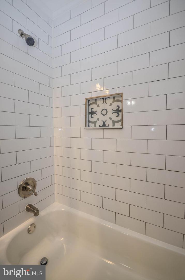 2315 Plyers Mill Road Silver Spring, MD 20902 - Photo 10 of 28 a bathroom with a bathtub and shower