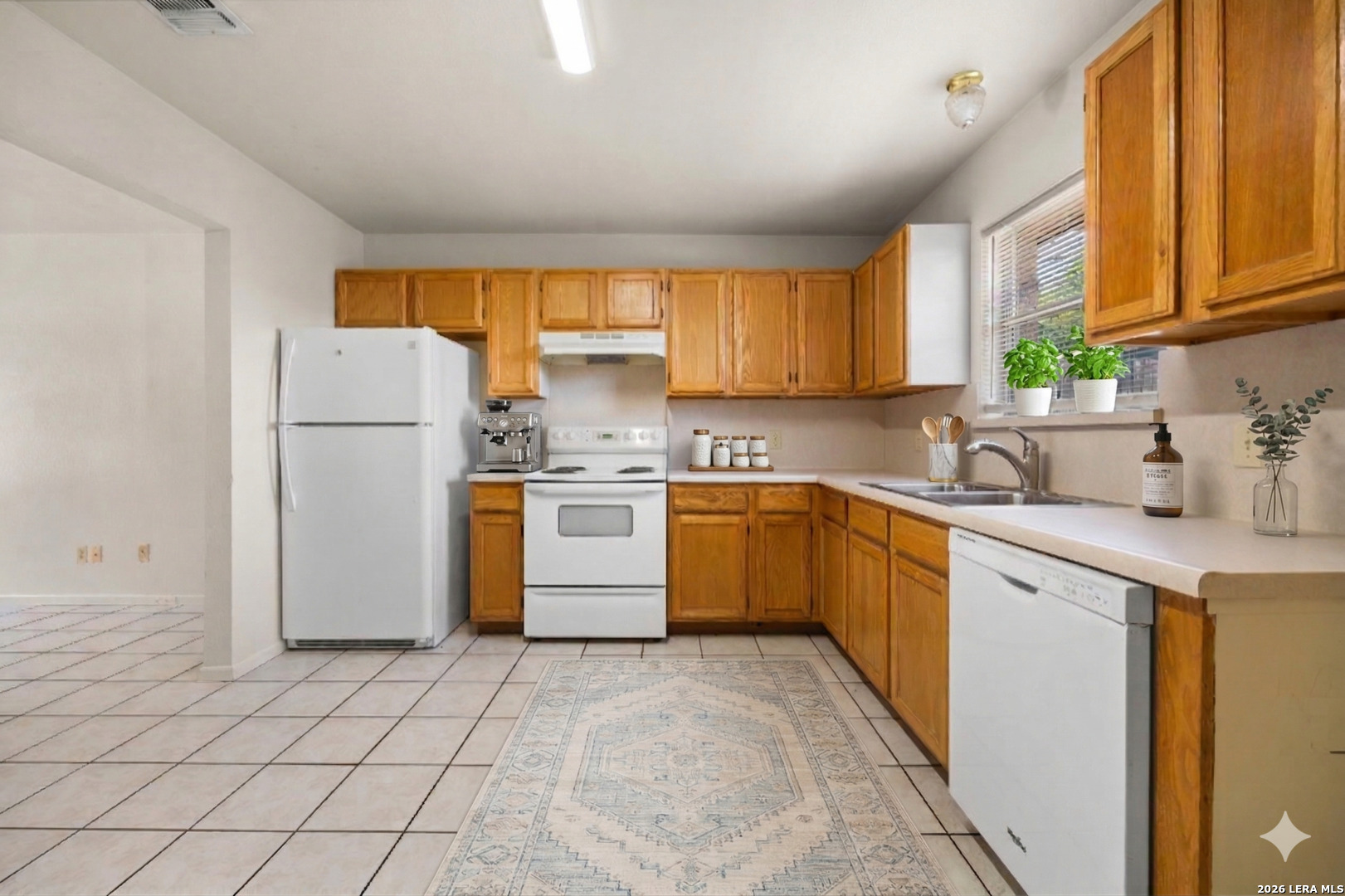 1118 West Goodwin Street Pleasanton, TX 78064 - Photo 5 of 23 a kitchen with a refrigerator sink and cabinets