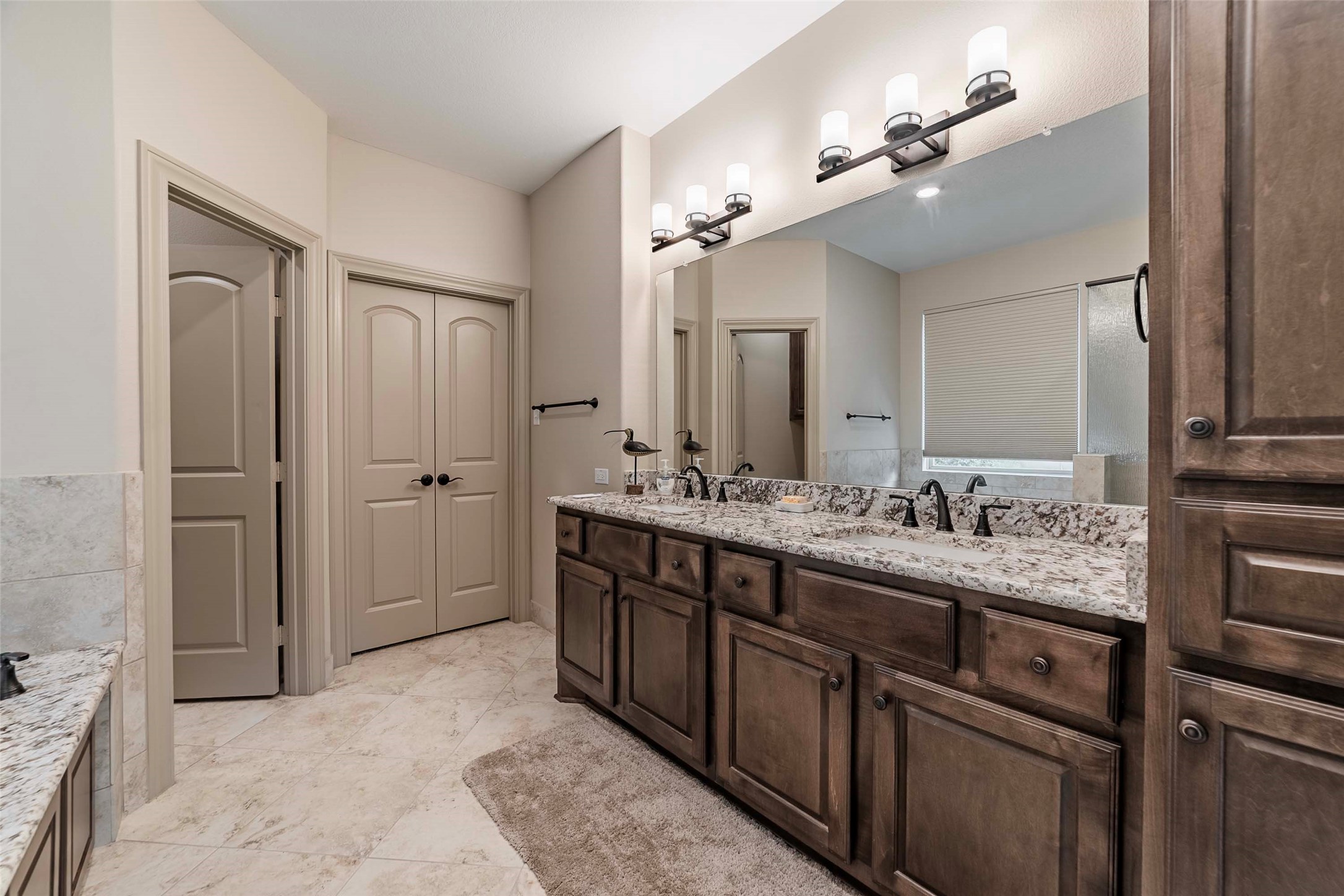 9695 County Road 321 Caldwell, TX 77836 - Photo 15 of 40 a bathroom with a granite countertop sink a toilet a mirror and shower