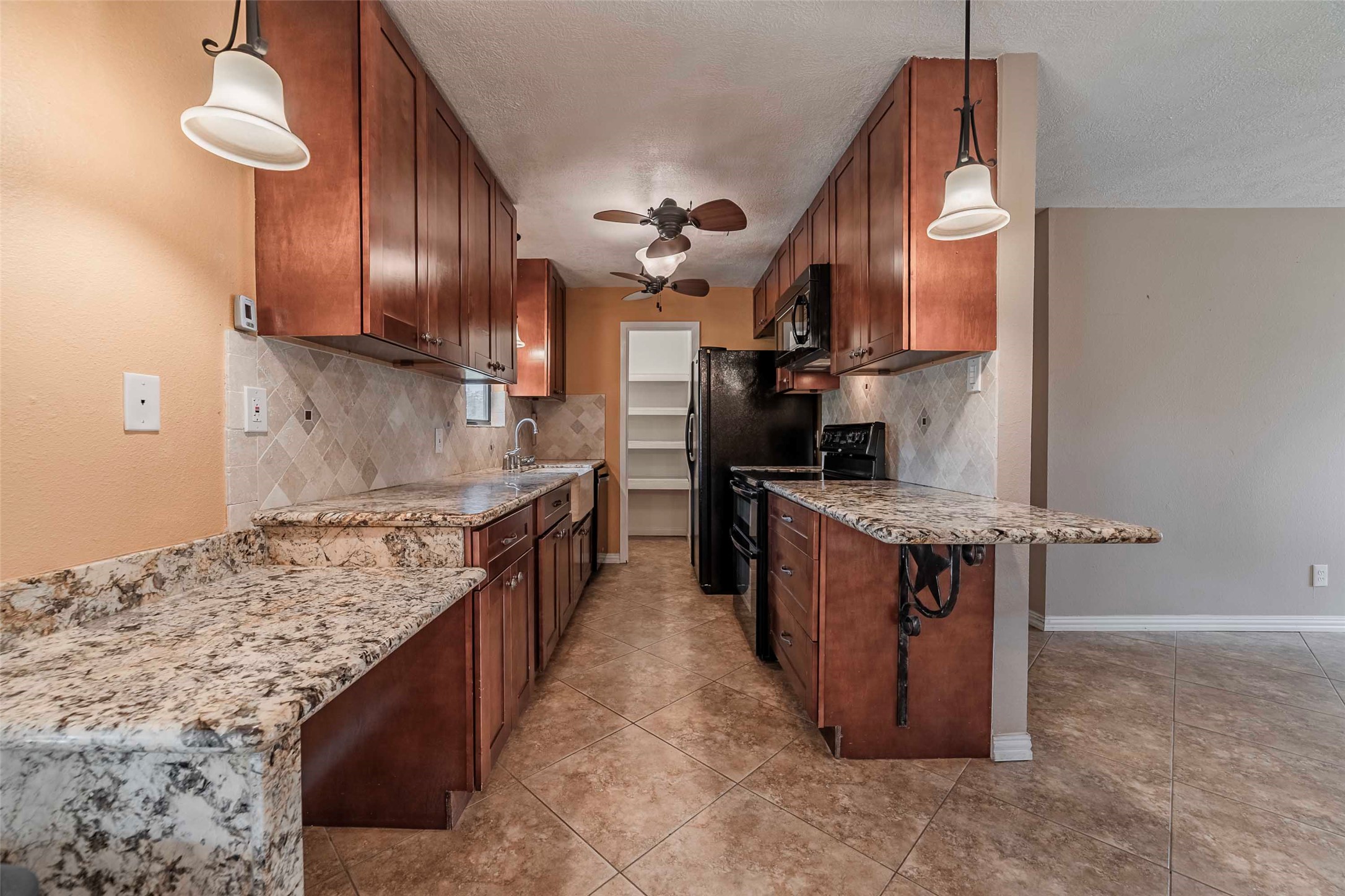 9695 County Road 321 Caldwell, TX 77836 - Photo 24 of 40 a kitchen with stainless steel appliances granite countertop a stove a sink and a refrigerator
