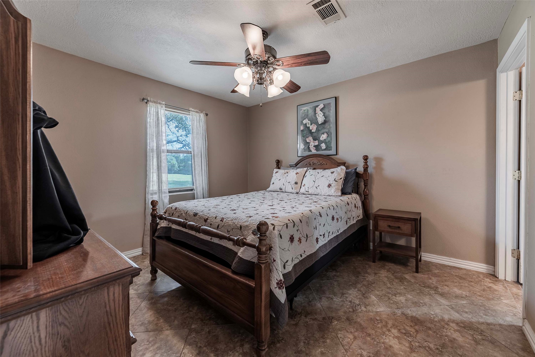 9695 County Road 321 Caldwell, TX 77836 - Photo 26 of 40 a bedroom with a bed and a flat tv screen on dresser
