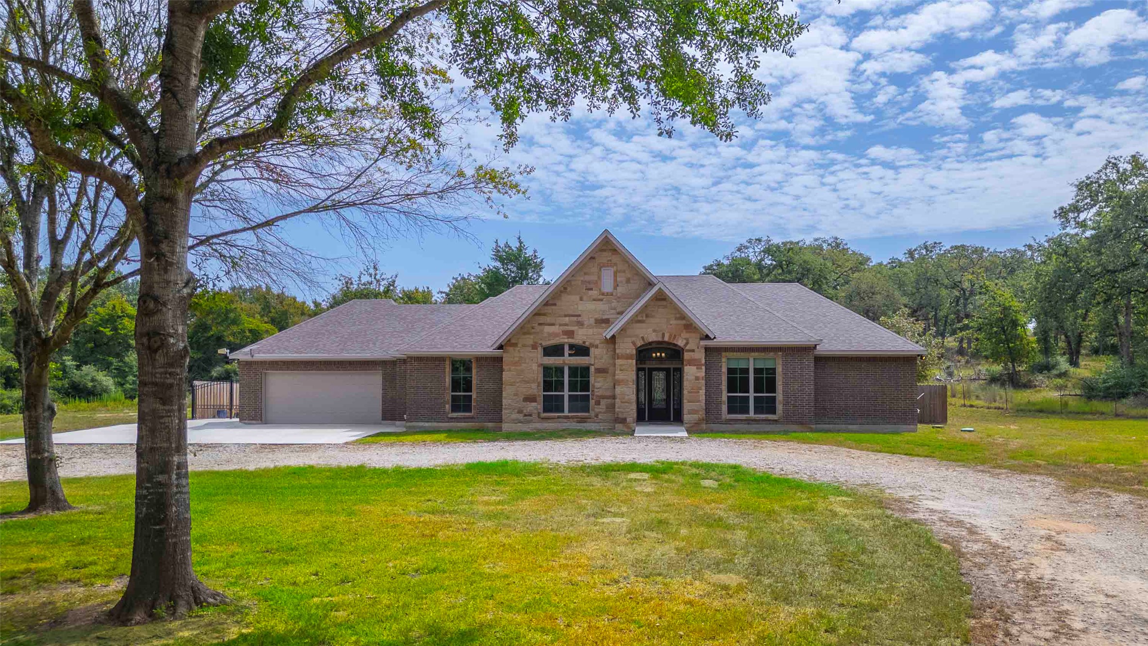9695 County Road 321 Caldwell, TX 77836 - Photo 5 of 40 a front view of a house with a garden and yard