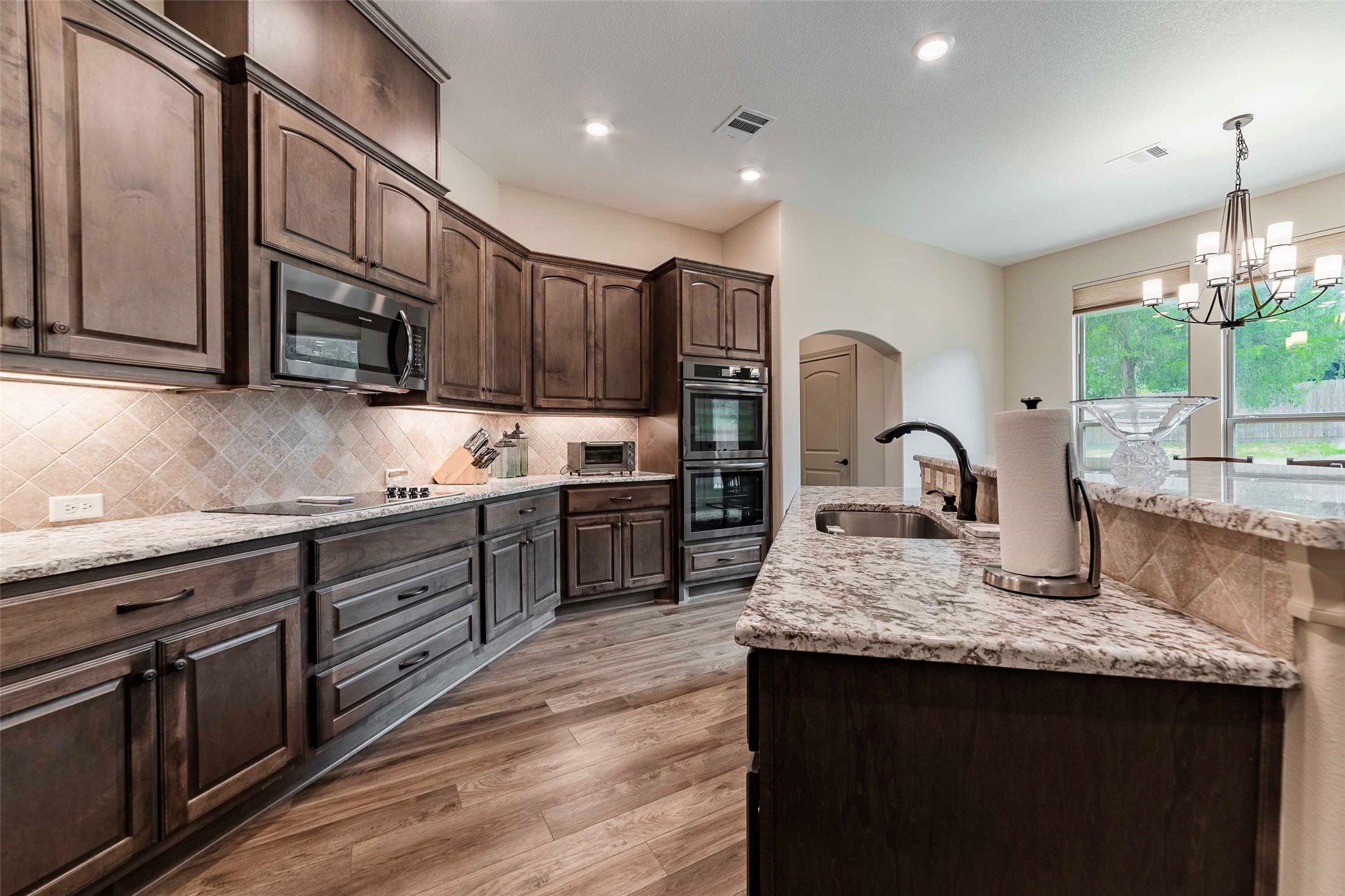 9695 County Road 321 Caldwell, TX 77836 - Photo 7 of 40 a kitchen with kitchen island granite countertop a stove and a sink