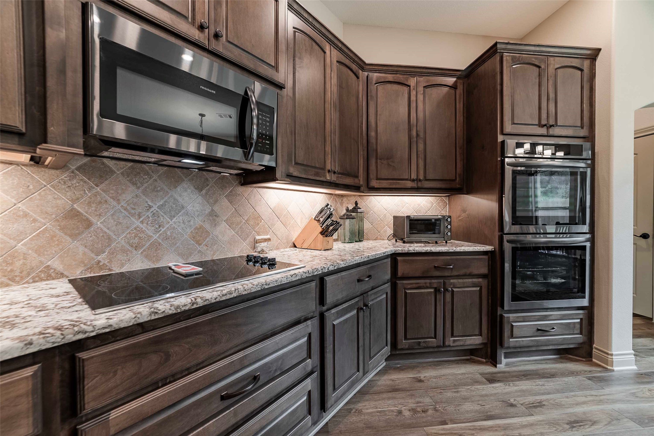 9695 County Road 321 Caldwell, TX 77836 - Photo 8 of 40 a kitchen with granite countertop a stove and cabinets