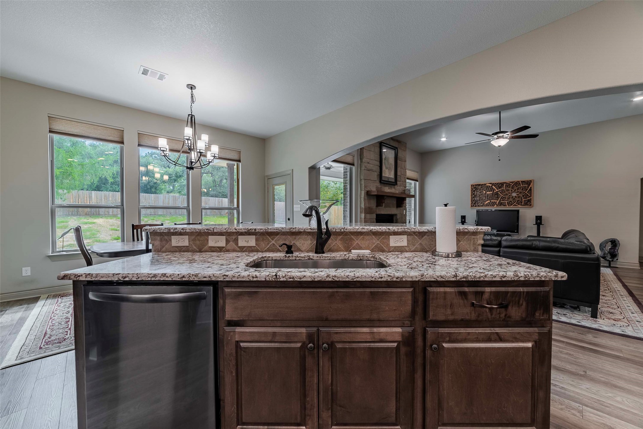 9695 County Road 321 Caldwell, TX 77836 - Photo 9 of 40 a kitchen with a granite countertop sink a window and chairs