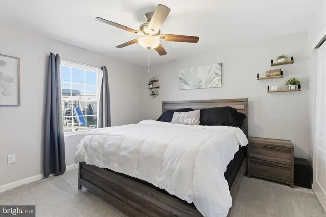 a bedroom with a large bed and a window