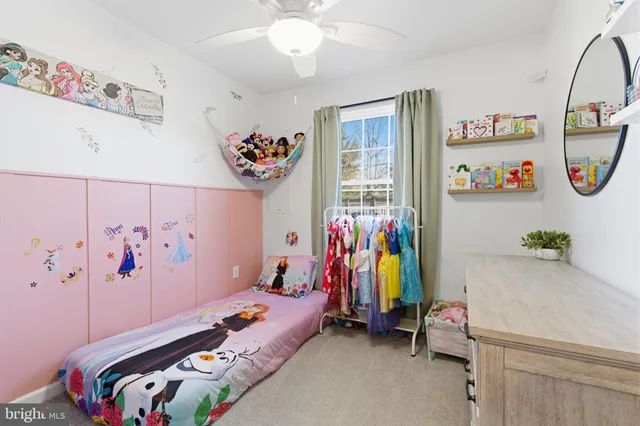 a view of a hallway with wooden floor and a bathroom