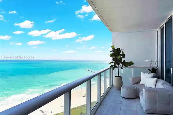 a view of balcony with couches and wooden floor