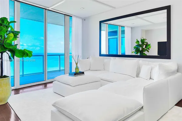 a living room with a couch and a potted plant