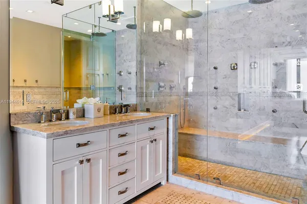 a spacious bathroom with double vanity and a mirror