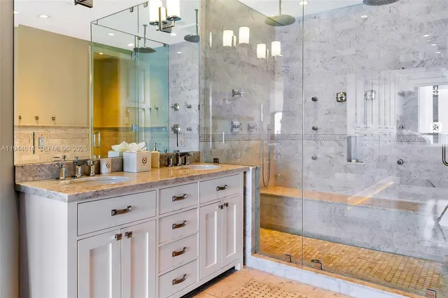 a spacious bathroom with double vanity and a mirror